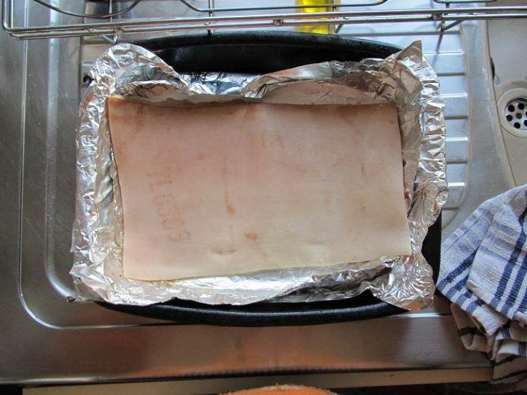 Raw pork belly in oven tray