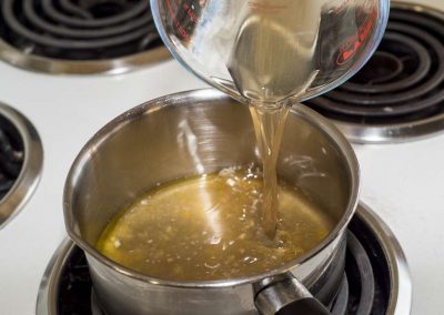 pour broth into pot