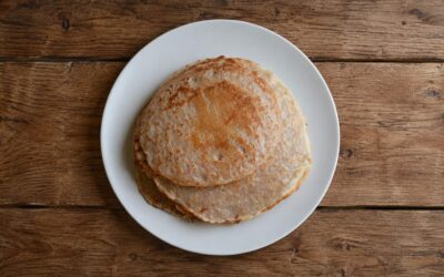 pancakes for dogs recipe freshly made pancakes sitting on a wooden worktop