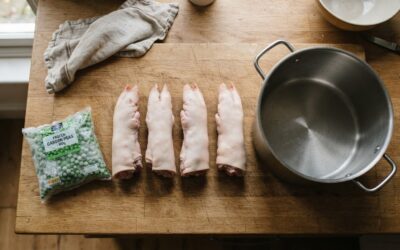 pig trotter dog food recipe pig trotters sitting on a kitchen worktop next to a stock pot